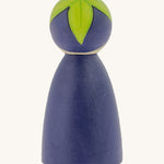 The back of the Peepul Aubergine Peg Doll, showing the hand painted purple peg doll body, and the green hand painted leaves on top of its head. The image is on a cream background