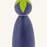 The back of the Peepul Aubergine Peg Doll, showing the hand painted purple peg doll body, and the green hand painted leaves on top of its head. The image is on a cream background