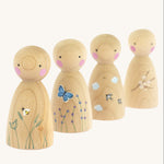 The Peepul Signs Of Spring Peg Doll Set stood one behind each other, are wooden with hand painted details. Each peg doll has a beautiful spring design, and from left to right is a bee flying above grass, a butterfly fling above flowers, swallows flying in the clouds, and a branch of white flowers delicately painted on the peg doll. The image is on a cream background