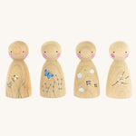 The Peepul Signs Of Spring Peg Doll Set stood in a row, are wooden with hand painted details. Each peg doll has a beautiful spring design, and from left to right is a bee flying above grass, a butterfly fling above flowers, swallows flying in the clouds, and a branch of white flowers delicately painted on the peg doll. The image is on a cream background