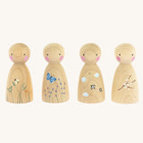 The Peepul Signs Of Spring Peg Doll Set stood in a row, are wooden with hand painted details. Each peg doll has a beautiful spring design, and from left to right is a bee flying above grass, a butterfly fling above flowers, swallows flying in the clouds, and a branch of white flowers delicately painted on the peg doll. The image is on a cream background