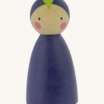 Peepul Aubergine Peg Doll, is a beautiful, hand painted peg doll with a purple body, a purple painted hat with green leaf, two small black dot eyes and two rosy cheeks. The image is on a cream background