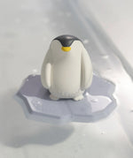 The Oli & Carol Penguin Bath Toy Set made from 100% Natural Rubber, stood on its base, floating on water