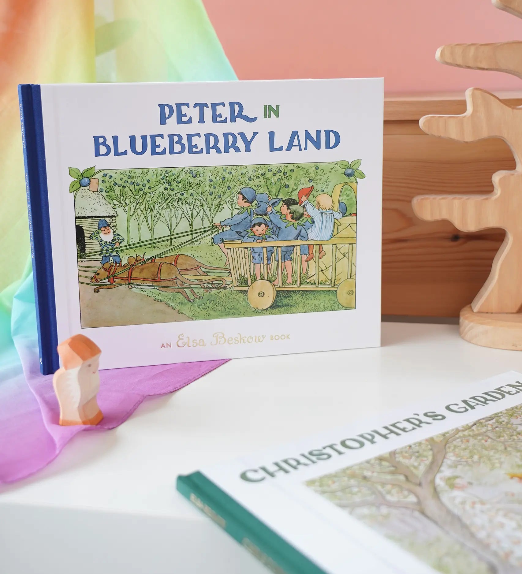 Peter in Blueberry Land children's hardback book by Elsa Beskow on shelf next to another book from the series, Christopher's Garden.