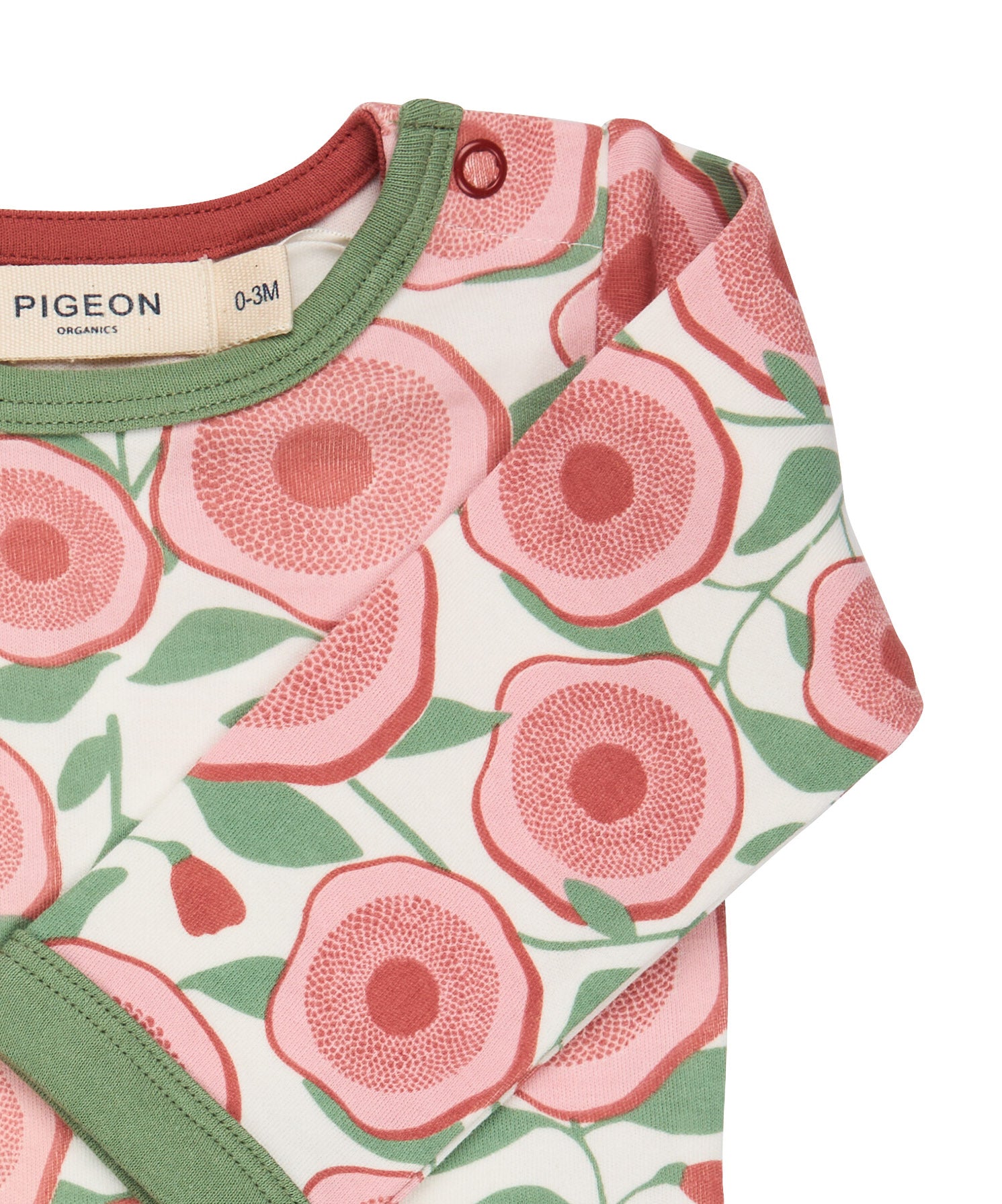 A close up of the Pigeon Organics floral bodysuit showing the popper fastener detail on the shoulder