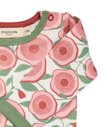 A close up of the Pigeon Organics floral bodysuit showing the popper fastener detail on the shoulder