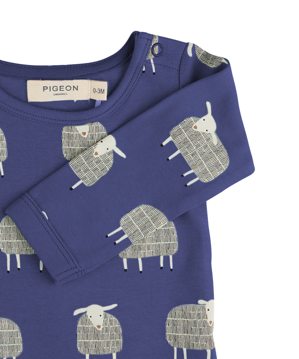 A close up of the Pigeon Organics navy sheep body showing the popper fastener detail on the shoulder