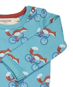 A close up of the Pigeon Organics turquoise cycling fox sheep body showing the popper fastener detail on the shoulder