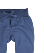 A close up of the Pigeon Organics blue sweatpants  available at Babipur showing the drawstring and elasticated waistband detail 