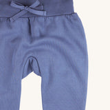 A close up of the Pigeon Organics blue sweatpants  available at Babipur showing the drawstring and elasticated waistband detail 