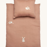 Roommate Doll Bedding Set - Rabbit in a pale pink colour with adorable rabbit print. The image shows a blanket and a pillow, on a cream background