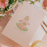 The Olli Ella Limited Edition Blossom Buds Gift Set - Tulip box on a pink background with flowers