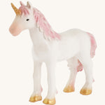 A closer look at the The Green Rubber Toys Rainbow Unicorn with a white body and pink details on the tail and mane and golden hooves and horn.