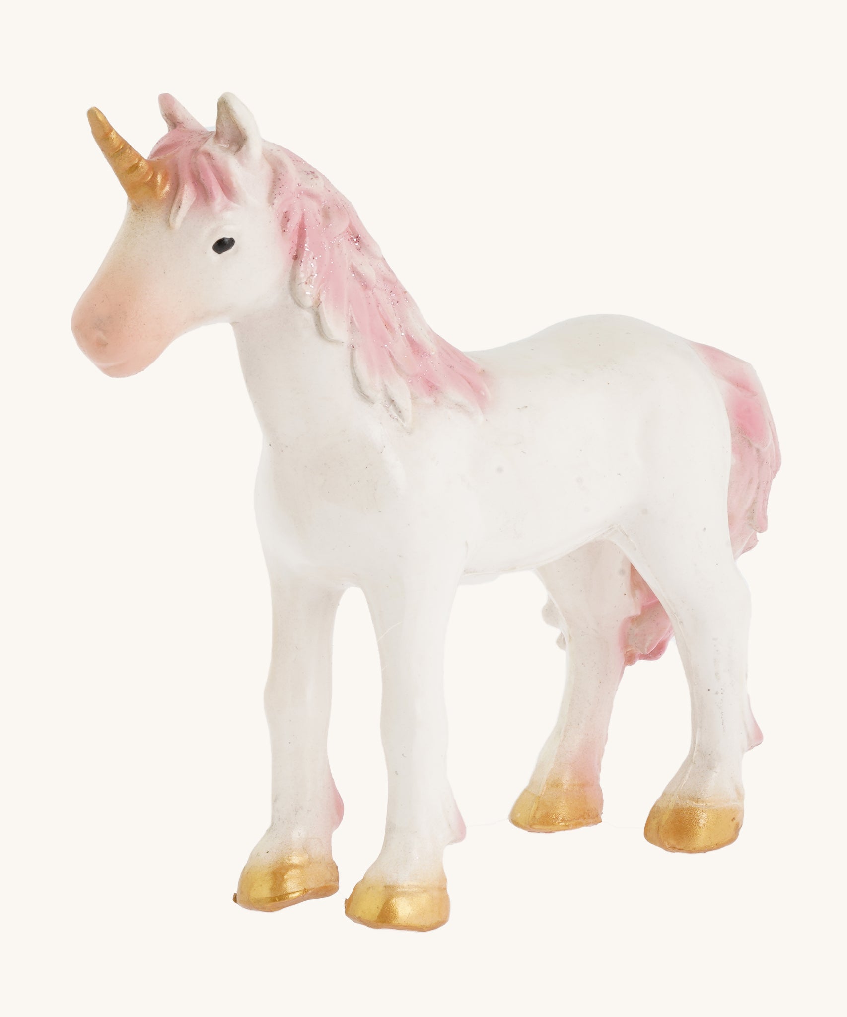 A closer look at the The Green Rubber Toys Rainbow Unicorn with a white body and pink details on the tail and mane and golden hooves and horn.