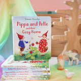 Pippa and Pelle cosy home children's board book by Daniela Drescher, stacked in the Babipur playroom with other books from that series.