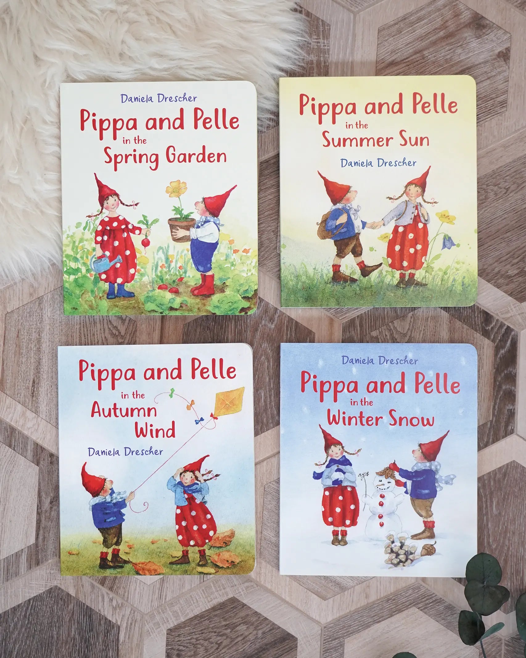 Pippa and Pelle seasonal children's board book series by Daniela Drescher (spring garden, summer sun, autumn wind and winter snow).