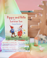 Pippa and Pelle Summer Sun children's board book by Daniela Drescher, stacked with books from that series, in the Babipur playroom. 