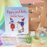 Pippa and Pelle Winter Snow children's board book by Daniela Drescher, stacked with books from that series, in the Babipur playroom. 