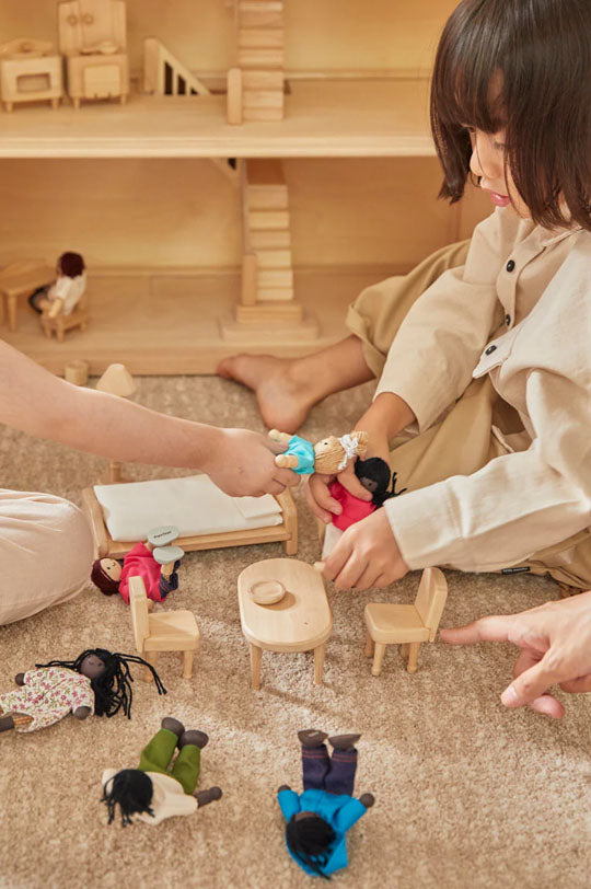 Kids playing with PlanToys family dolls and the Vicotrian Dolhouse, heirloom quality wooden toys, to represent PlanToys at Babipur, official UK stockist.