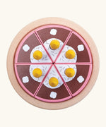 Overheard view of a PlanToys birthday cake wooden set showing brown slices with candles on a serving plate