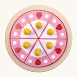 Overheard view of a PlanToys birthday cake wooden set showing pink slices with candles on a serving plate