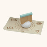 Pom Pom dough ball with a cutter on top from the PlanToys bread loaf set