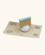 Pom Pom dough ball with a cutter on top from the PlanToys bread loaf set