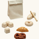 PlanToys wooden bread play set. Includes a cotton bag, rolls with velcro tabs, a knife and pastries 