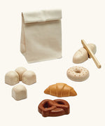 PlanToys wooden bread play set. Includes a cotton bag, rolls with velcro tabs, a knife and pastries 