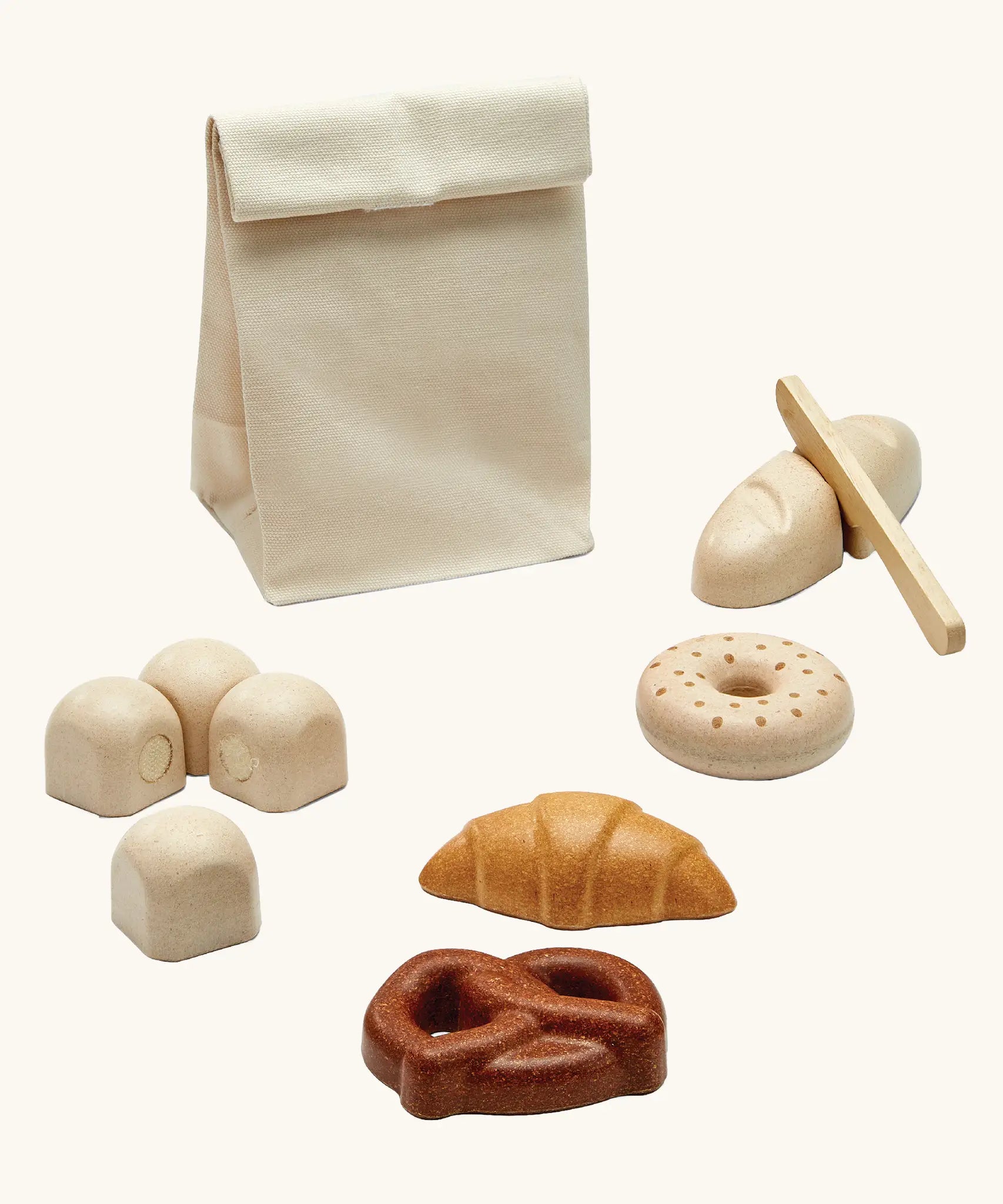 PlanToys wooden bread play set. Includes a cotton bag, rolls with velcro tabs, a knife and pastries 