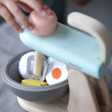 Plan Toys cake mixer play set showing a close up of the grey bowl filled with wooden play food