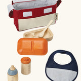 PlanToys doll feeding set. Includes a carry bag, bottles, bib and a bowl