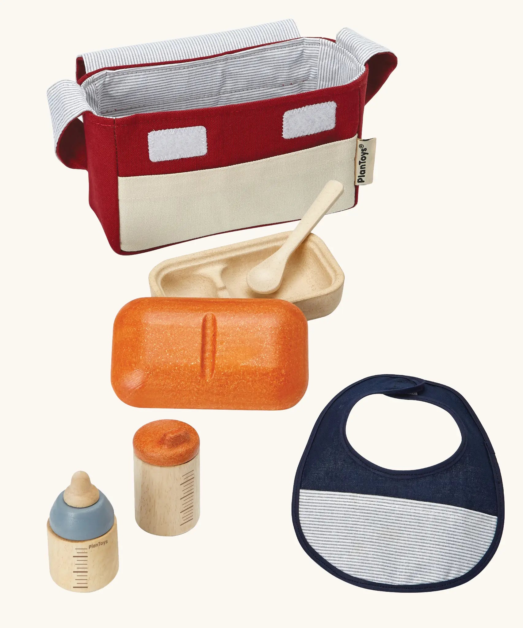 PlanToys doll feeding set. Includes a carry bag, bottles, bib and a bowl