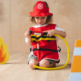 Child holding the hose from the PlanToys fire fighter play set wearing the vest and hat