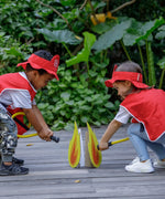 Children pretend playing wearing the vest, hat from the PlanToys fire fighter set and holding the hose