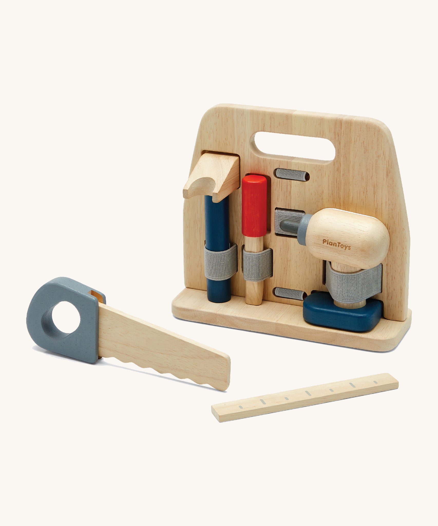 Plan Toys wooden handy carpenter set available at Babipur. Set including a saw, drill, chisel, claw hammer, ruler and a wooden tool stand. Each tool is held by an elasticated fabric band.