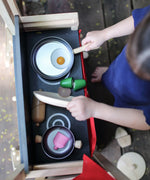 Overhead view of a kitchen setup with play food on the PlanToys Play centre