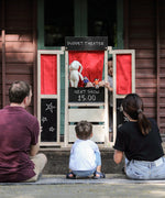 Children playing with the PlanToys play centre made into a puppet show