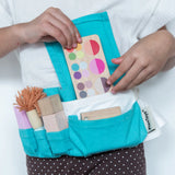 Child wearing the blue waist bag filled with tools and accessories from the PlanToys make up set