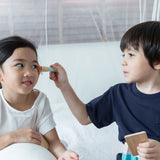 Child playing with the brush from the PlanToys make up set