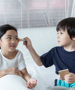 Child playing with the brush from the PlanToys make up set
