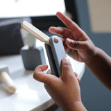 Child holding a working shaving blade from the PlanToys shaving play set showing scale