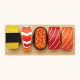 Overhead view of the different PlanToys  wooden sushi pieces on a service board