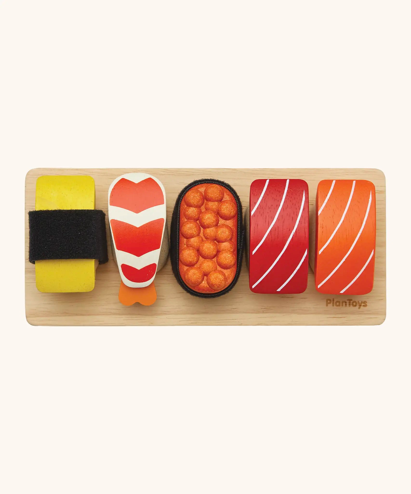 Overhead view of the different PlanToys  wooden sushi pieces on a service board