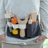 Front of child wearing the PlanToys toys tool belt 