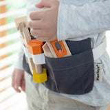 PlanToys tool belt play set showing different tools pockets, worn by a child