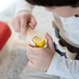 Child using the wooden spanner on a bolt  from the PlanToys tool play belt set 