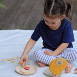 Child playing with the PlanToys wooden waffle play set.