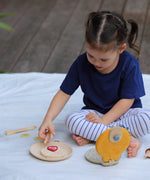 Child playing with the PlanToys wooden waffle play set.
