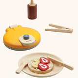 PlanToys wooden waffle play set. Includes a maker, sauce, cutlery and play food pieces